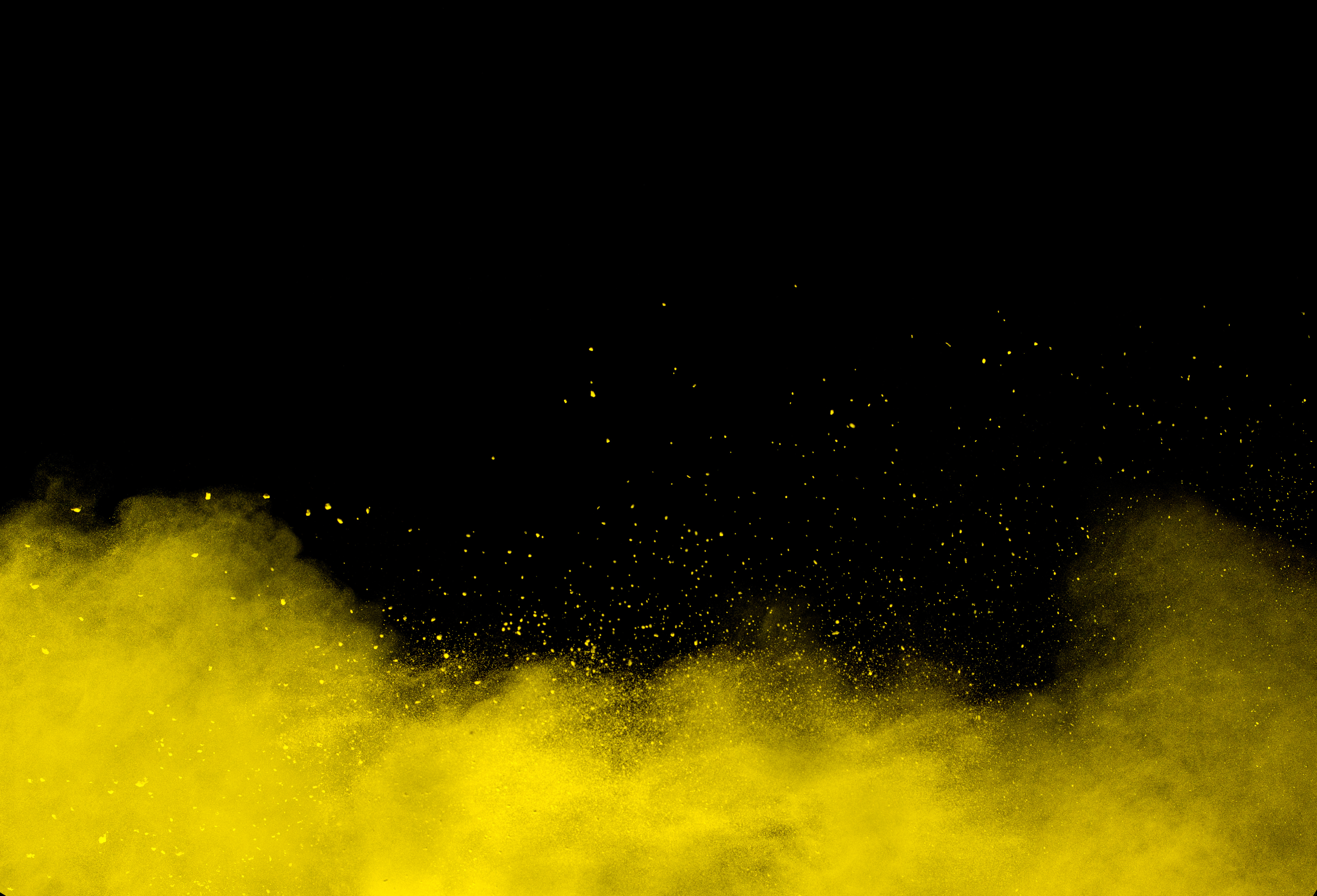 Yellow color powder explosion on black background.